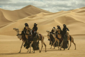 Men riding camels