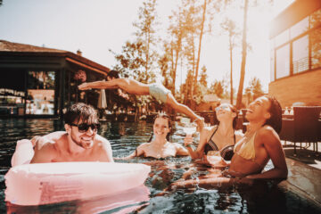 Group of Young Happy People Swimming in Pool