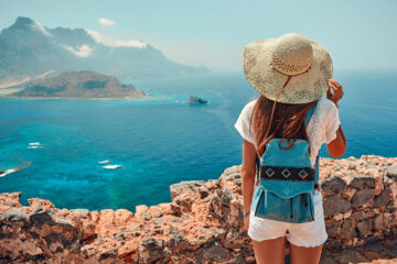 Girl with backpack, tourism by sea