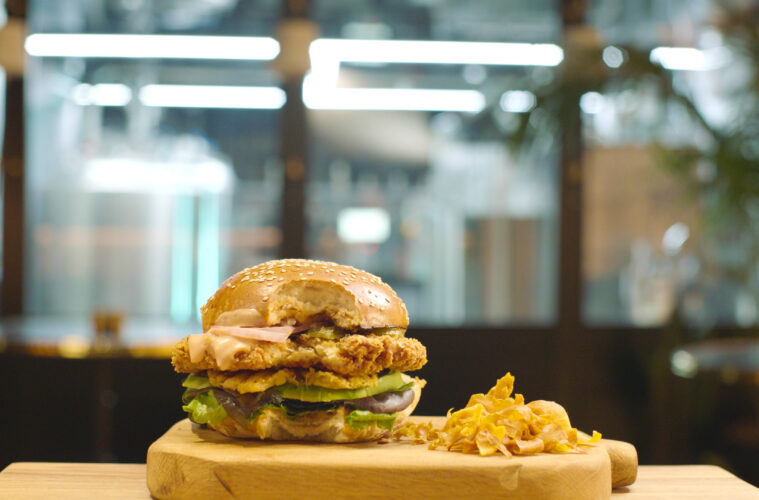 SuperMeat's chicken burger, pilot plant in the back