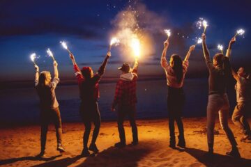Friends on beach with flares