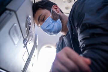 Man in mask on plane