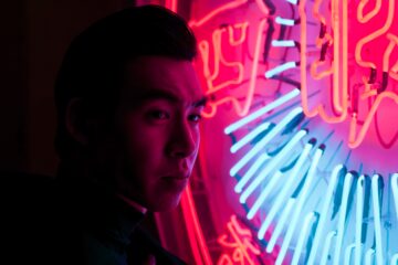 Chinese man with neon sign
